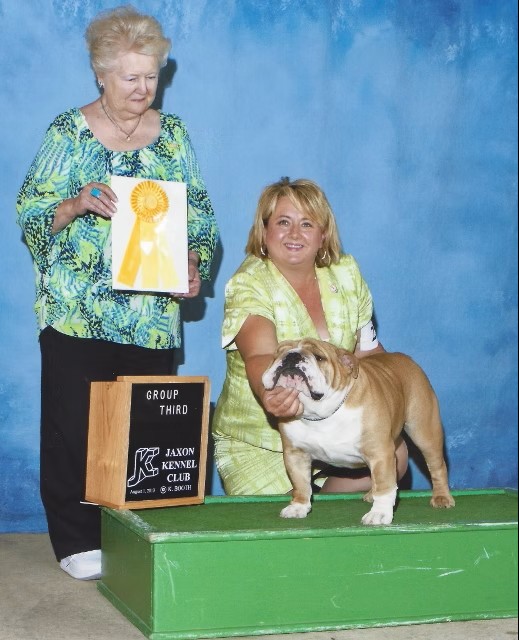 Bulldog With Show Judge and Owner